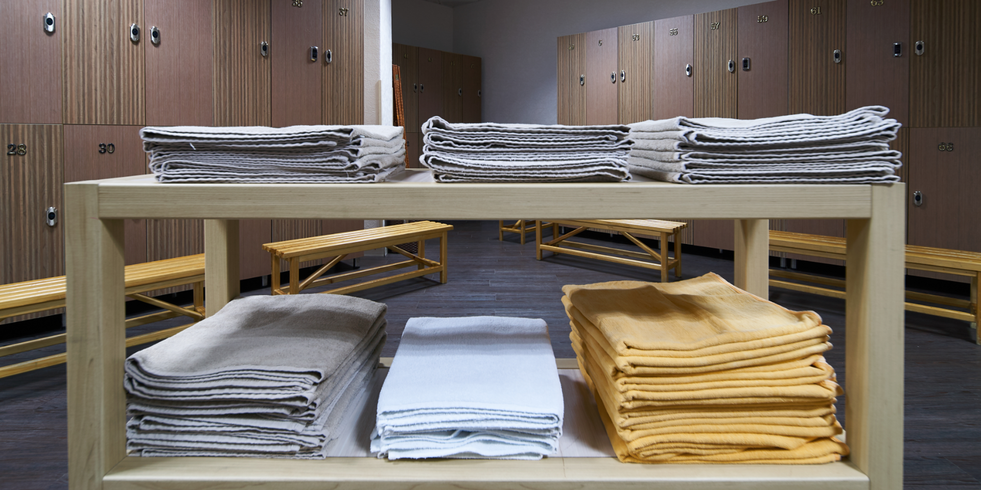 Gym towels on an open shelf in locker room